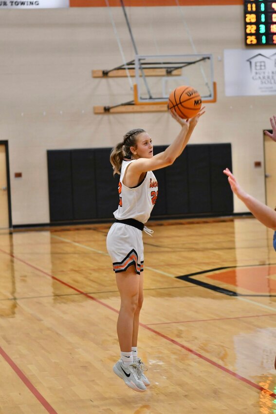 Kaegan Young (22) nails one of her three three-pointers in Saturday's win over Moore County. Young led all scorers with 24 points, including 18 in the second half alone.