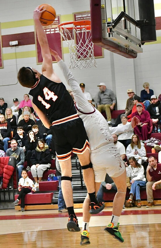 Cooper McElroy dunks home two of his 11 points late in the first half of Cascade's non-district upset win at No. 3 Cannon County on Tuesday night.