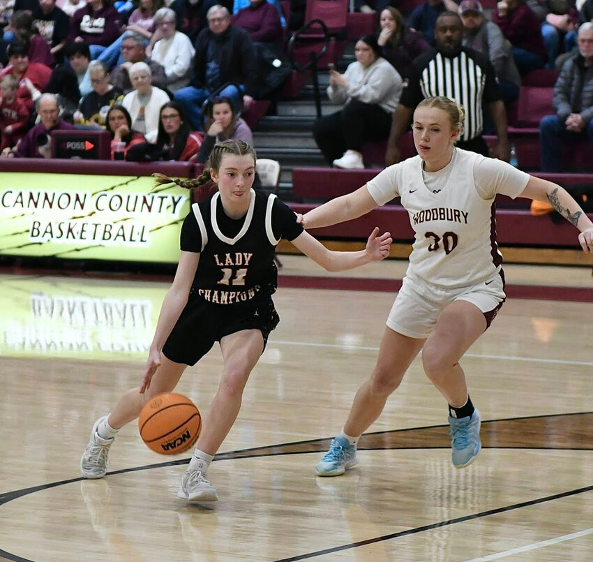 Lizzie Keele (11) drives past Elly Bain (30) into the lane against the Lionettes. Keele scored all seven of her points in the second half of Tuesday's loss.