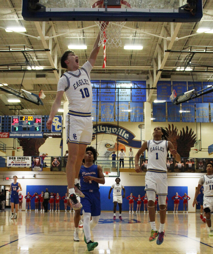 Jack Conditt (10) attempts to slam down two of his 11 points in the fourth quarter of Friday's win over Warren County while teammate Jordan Taylor (1) jumps in unison.