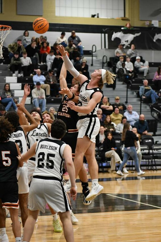 Cascade's Tyler Rodgers (25) floats in two of his eight points despite Loretto's Mason Tidwell (13) presenting a heavy contest. Rodgers tacked on four rebounds in Friday's road loss.