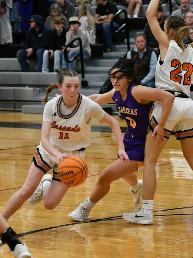 Cascade's Lizzie Keele (11) uses a Kaegan Young (22) screen to get free of Community's Mattie Maxey (0) in Cascade's loss to Community on Tuesday. Keele finished with nine points.