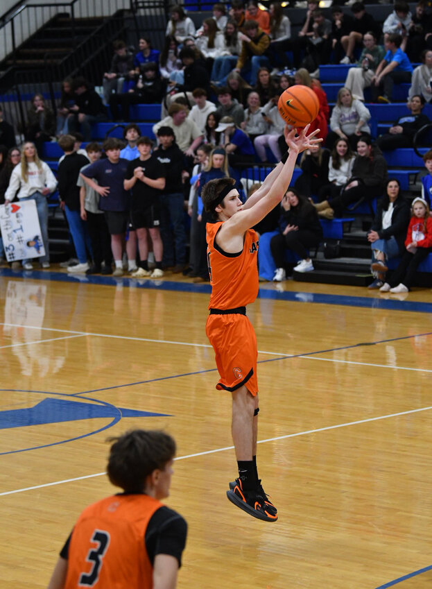 Cascade's Cooper McElroy (14) launches a first-half three-pointer in Friday's win at Chapel Hill. McElroy finished with a game-high 20 points on an efficient 7-of-11 shooting while grabbing three rebounds, dishing out four assists, and swiping two steals.