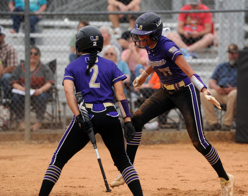 Abby Murrill celebrates with Alana Tate after scoring the game&rsquo;s first run in the first inning.