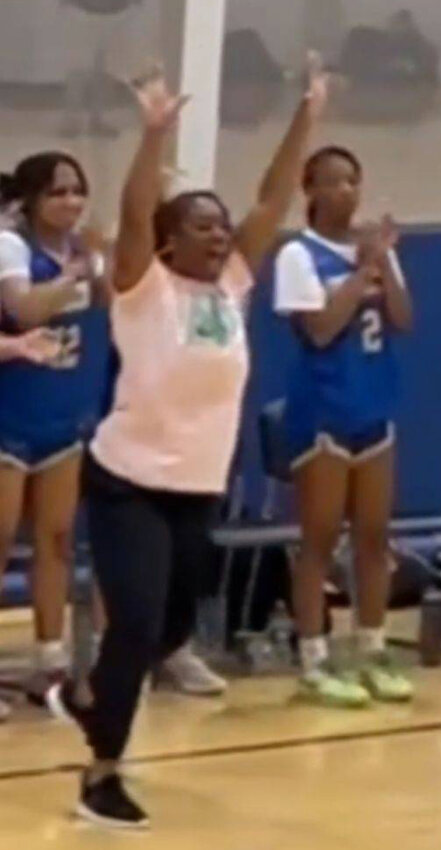 Keisha Jarrett (center) celebrates on the sidelines at the MTSU summer camp.