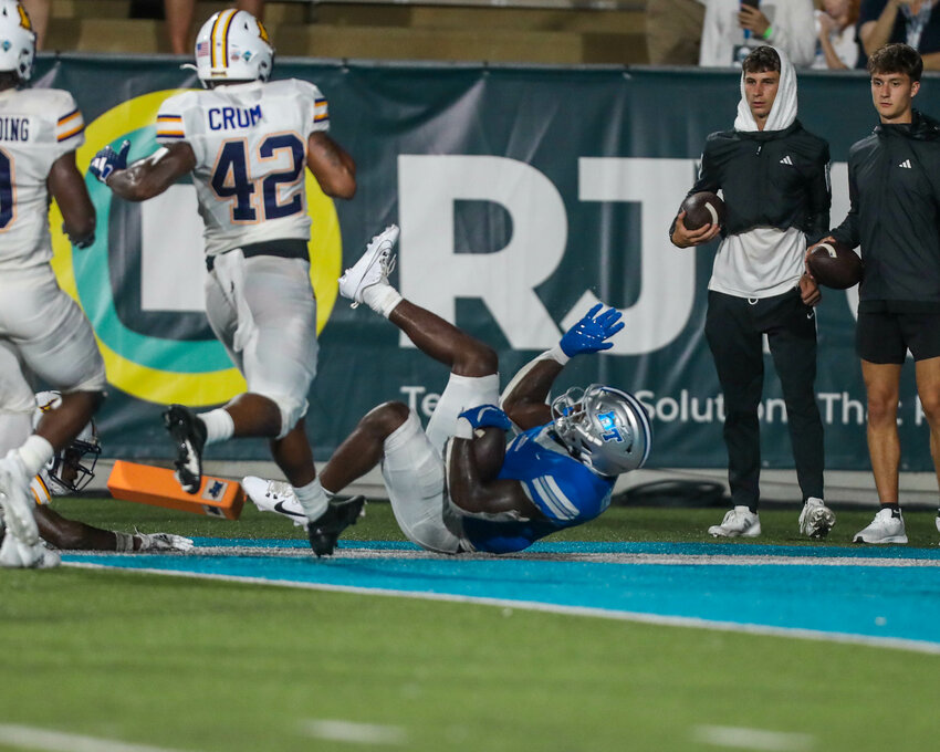 Frank Peasant (3, blue) dives into the end zone for the game-winning TD vs Tennessee Tech with 15 seconds left in the fourth quarter. Peasant finished with 10 carries for 49 yards and 2 TDs on Saturday night.