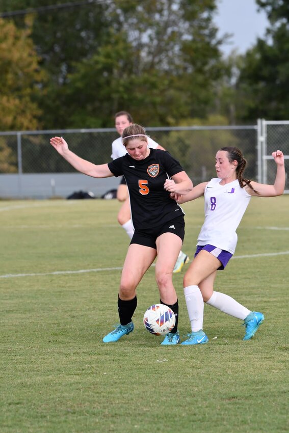 Cascade's Sophie Ray (5) and Community's Addison Prince (8) battle for the ball in the first half of Tuesday's district semifinal.