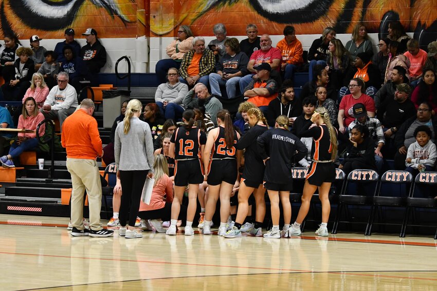 Cascade huddles during a timeout late in the game at Fayetteville on Friday night in their 68-66 (OT) loss.