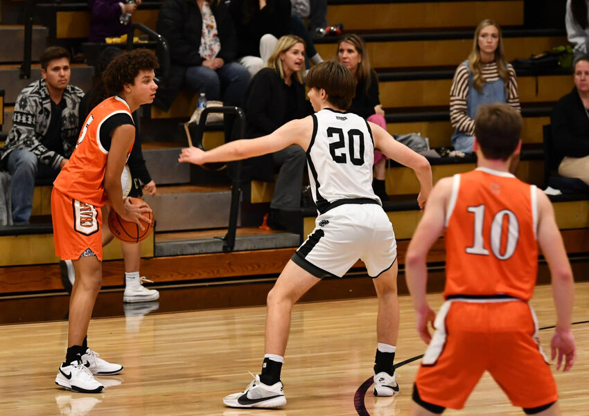 Kaleb Kelso (5, with ball) gets ready to break down Central Magnet's Henry Long (20) as his teammate, Henry Stone (10), looks on. Kelso reached the 20-point threshold for the second consecutive game in Monday's blowout victory.