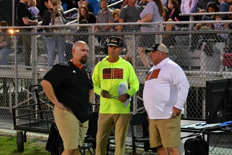 Glenn Tidwell (middle) in his previous stint at Cascade. He was the Champions' defensive coordinator from 2021-23 before taking the job to lead the Vikings' program.