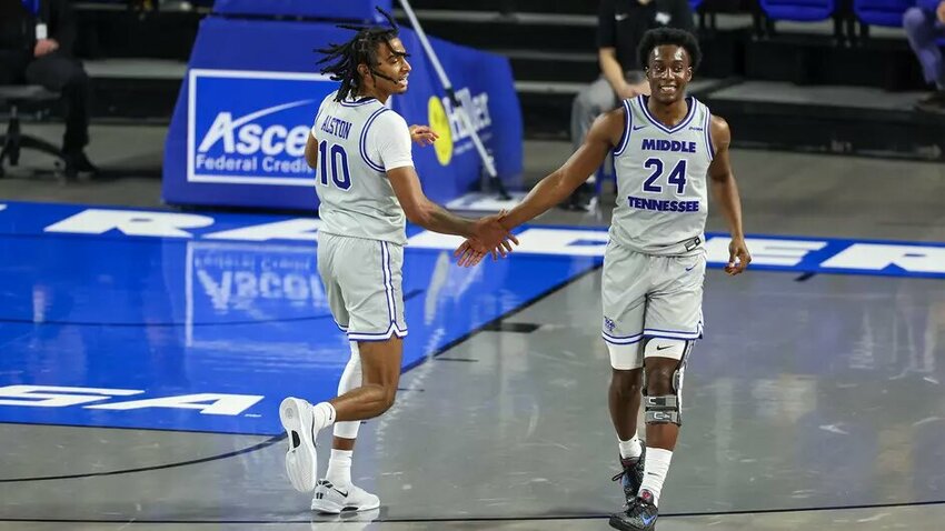 Torey Alston (10) and Camryn Weston (24) high-five during MTSU's two-point home win against Lipscomb.