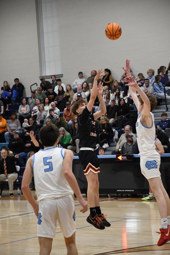 Noah Watson (2) fires away from downtown at Moore County. He finished with a career-high 27 points and eight-made three-pointers in his first game this season as the sixth-man.