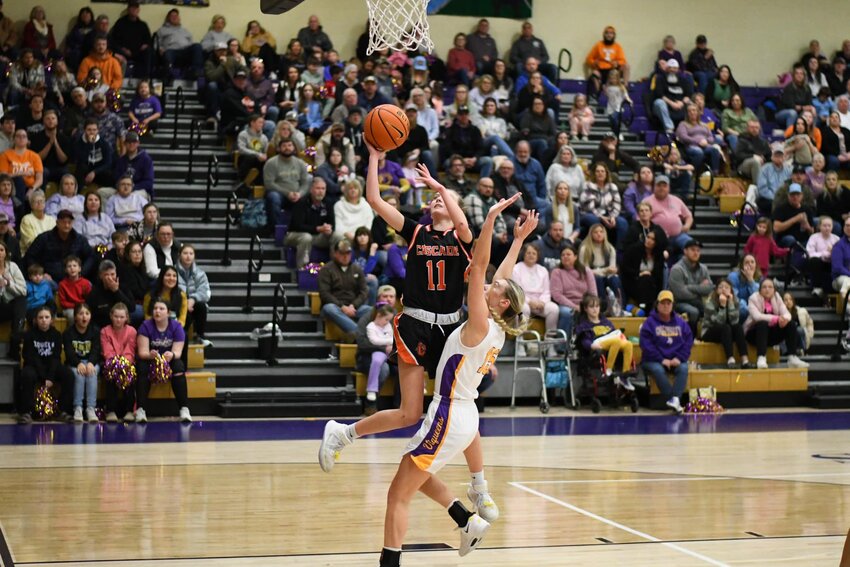 Lizzie Keele (11) finishes off a steal with an and-one layup on Community's Taylor Wessner. Keele scored 10 of her 12 points in the second half.