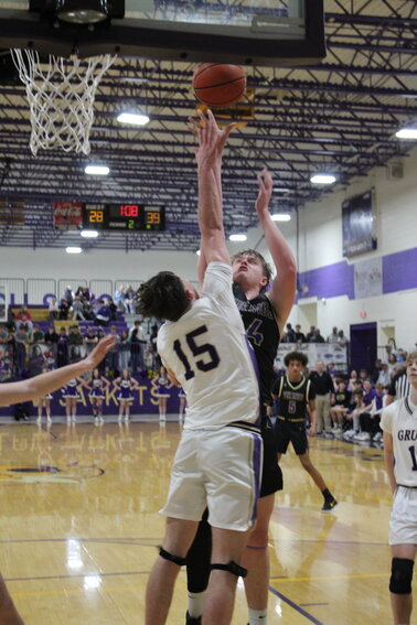 Austin Stickler (44) hits for two of his 12 points over Sam Parson (15) at Grundy County on Friday night.