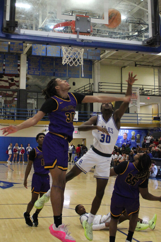Shelbyville Eagle Jevon Lee (30) goes in for a layup and scores two of his 20 points against Columbia Central on Thursday.
