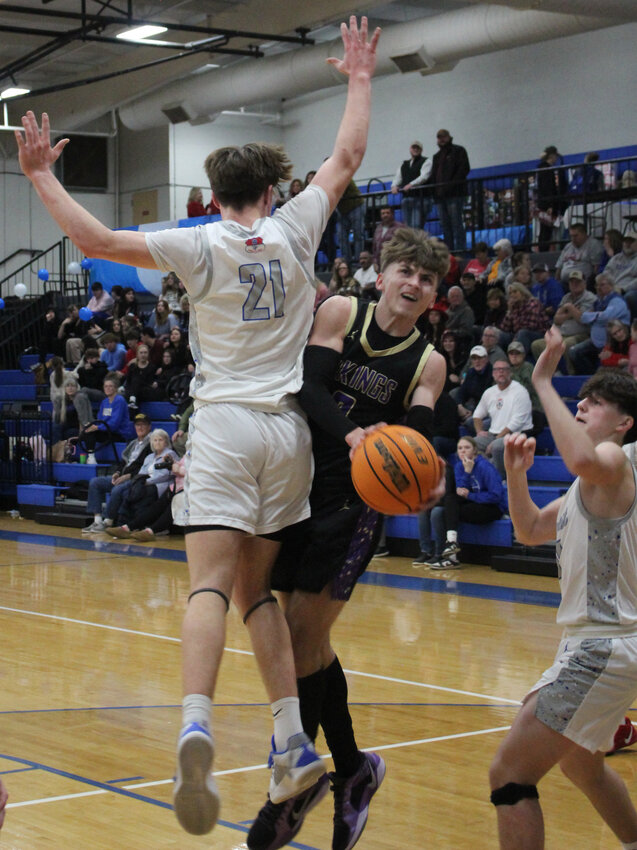 Community Viking Senior Landon Bergman (0) is draws contact while going up for a layup in Community's 68-63 win against Chapel Hill on Friday. Berman finished with seven points.