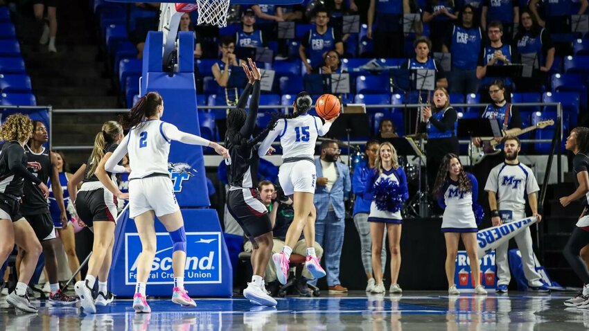 Ta'Mia Scott (15) lays in two of her team-high 20 points in Thursday's win over NMSU.