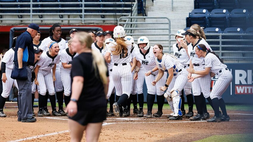 Jana Want (16) touches home plate following her 3-run home run in the third inning. She finished game one with 6 RBIs.