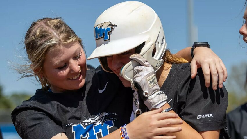 Jana Want (16, right) celebrates with her teammates after clinching the series win against WKU on a walk-off home run in the bottom of the seventh on Sunday.
