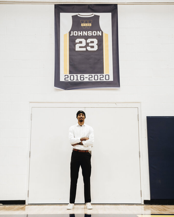 Former Webb star, Keon Johnson, standing underneath his now-retired jersey inside the Barton Athletic Center. Johnson is hosting his now-annual basketball camp for the third consecutive year starting on Wednesday, July 23.