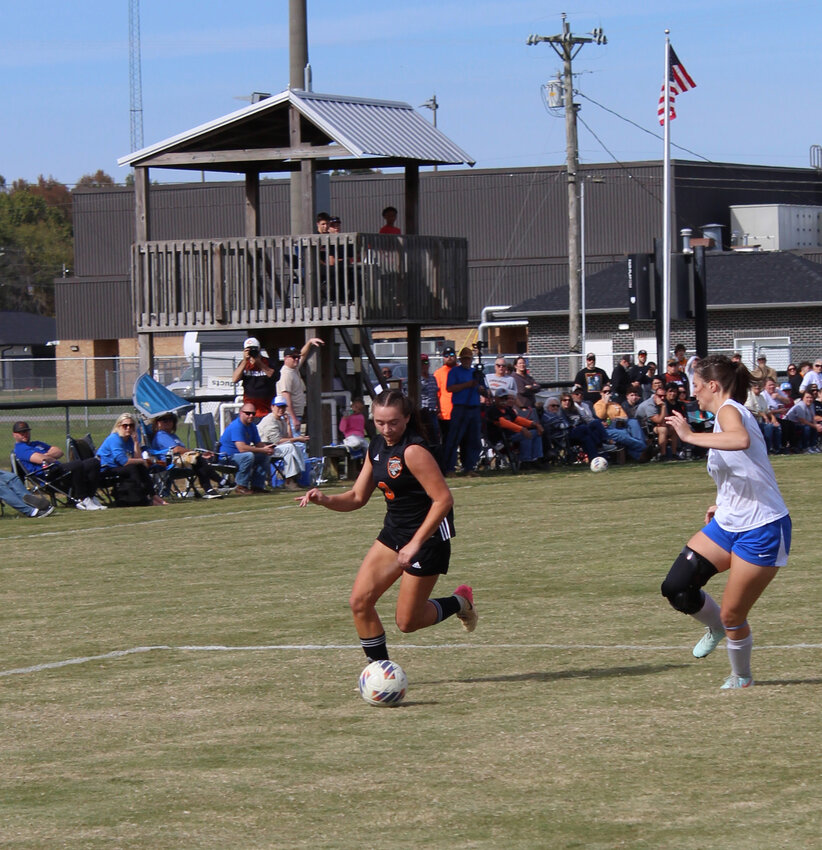 Lexi Comstock (8) dribbles into the Huntington box during Saturday's substate win against Huntington. Comstock's hat trick brought her season tally up to a remarkable 32 goals in just 17 games played.
