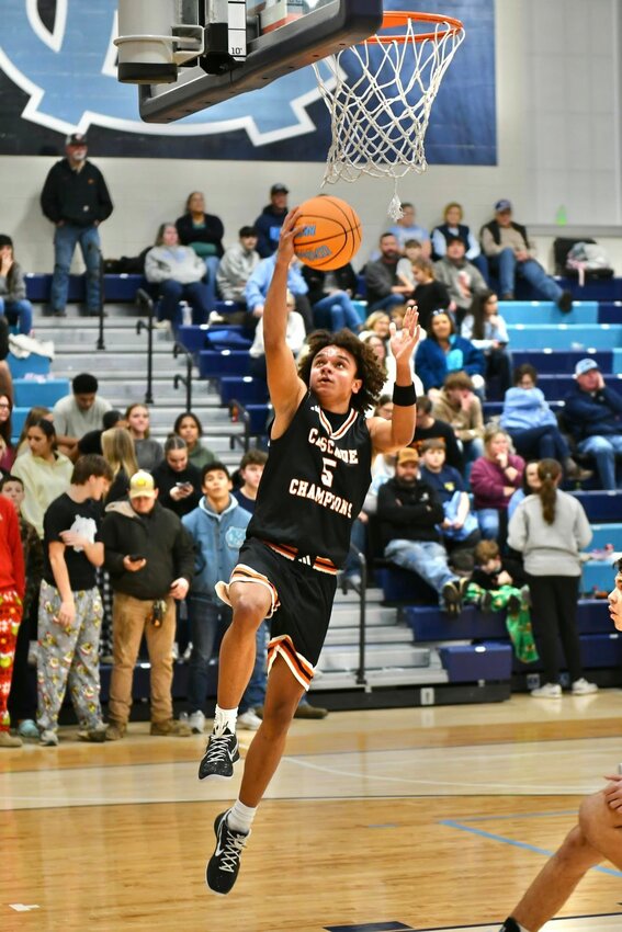 Kaleb Kelso (5) lays in two of his season-high 26 points on an efficient 10/17 shooting clip at Moore County on Tuesday night. Kelso also pulled down five rebounds, dished out two assists, and swiped two steals.