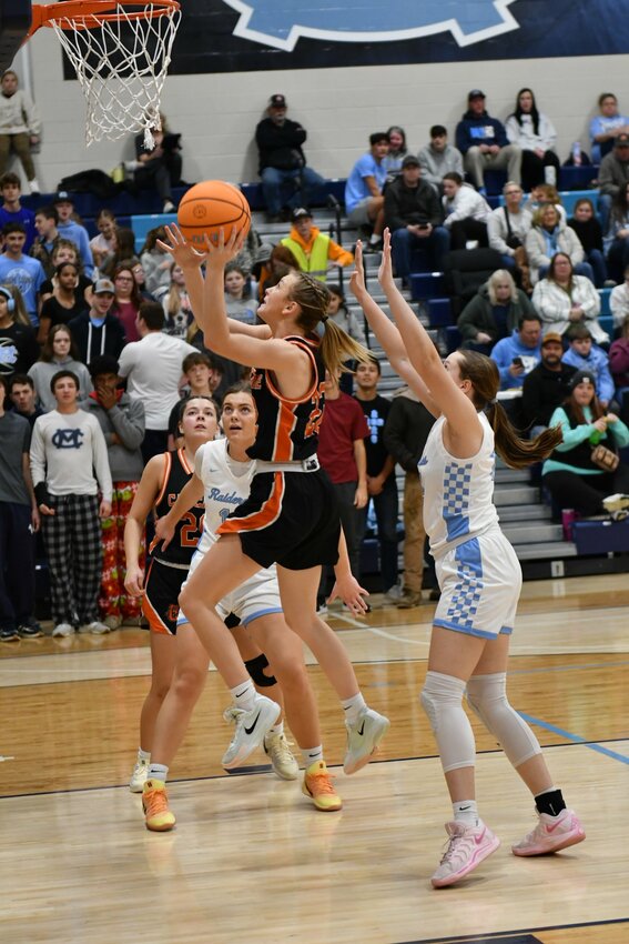 Kaegan Young (22) drives for two at Moore County on Tuesday night. Young finished with a double-double - 18 points and 13 rebounds - and was the game's leading scorer in the loss.