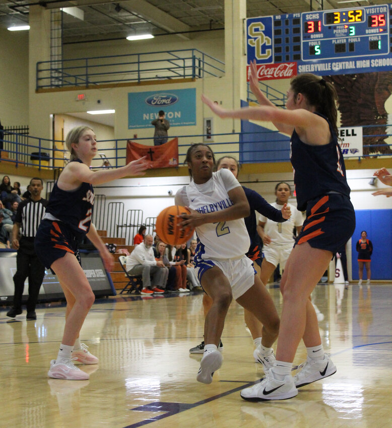 Janiya Leslie (2) euro-steps her way around Summit's Sam Malcolm (22) in Thursday's win over Summit. Leslie finished with a team-high 16 points and hit the dagger three-pointer in the final minute.
