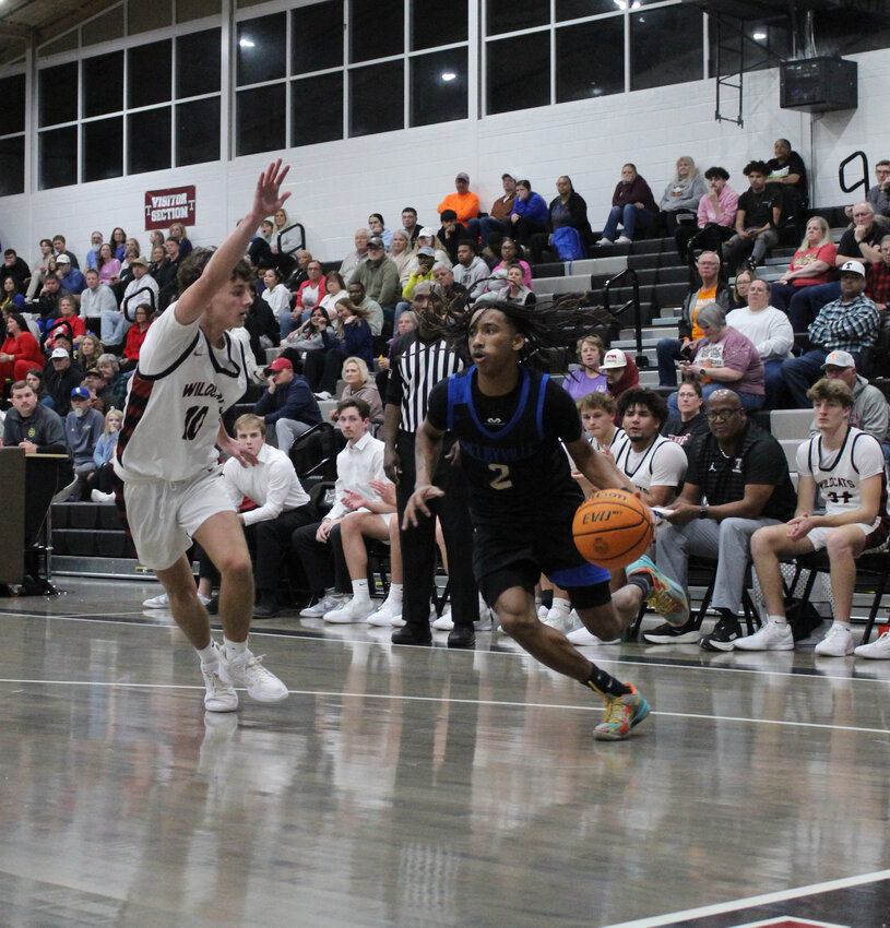 Tommie Cannon (2) drives baseline against Tullahoma's Alex Miller (10). Cannon scored a team-high 16 points in Tuesday's loss to the Wildcats.