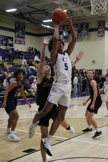 Jaxon Williams (5) lays in two of his 10 points in Tuesday's loss to Eagleville.