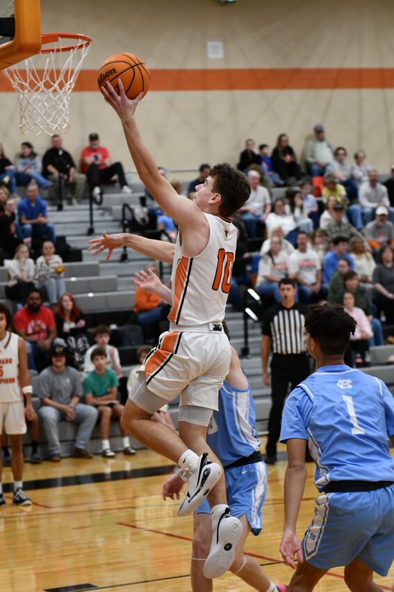 Henry Stone (10) soars in for two of his 12 points in Saturday's win over Moore County.