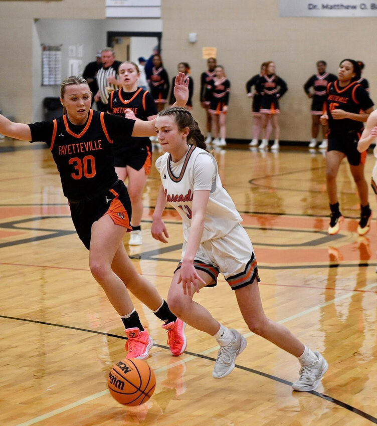 Lizzie Keele (11) drives past Fayetteville's Kalli Mooris (30) in Friday's 28-point win. Keele finished with a game-high 24 points while pulling down seven rebounds and dishing out five assists.
