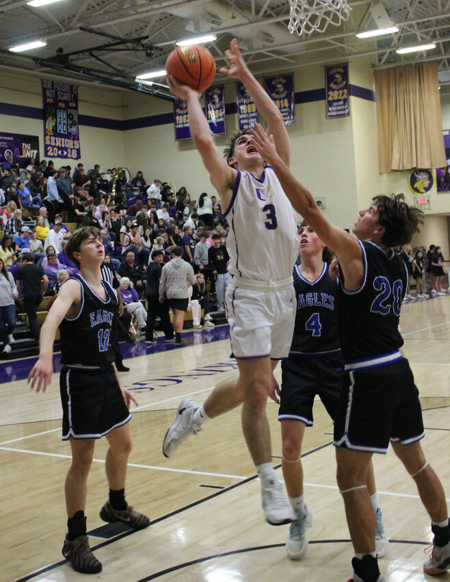 Charlie Haskins (3) attacks the basket for two of his 13 points in Friday's loss to Summertown.