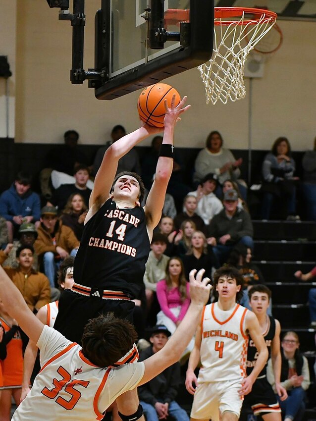 Cooper McElroy (14) hits the go-ahead and-one to complete Cascade's comeback at Richland on Saturday. McElroy finished with a team-high 21 points, six rebounds, and five assists.
