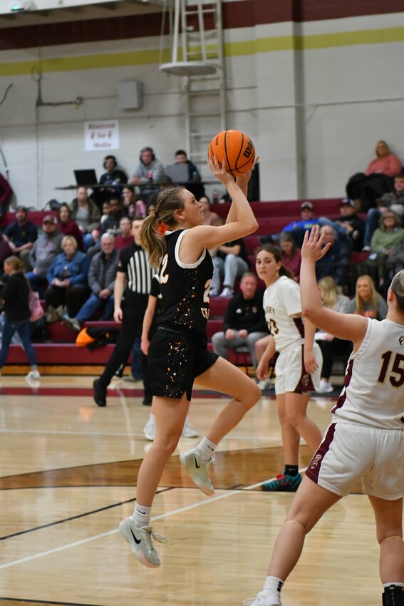 Kaegan Young (22) floats in two of her game-high 25 points over Cannon County's Abi Alexander (15) in Tuesday's road upset loss.