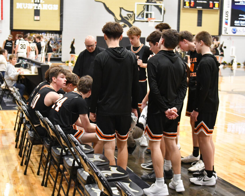 Cascade huddles during a timeout in Friday night's District 9-AA contest at Loretto. The Champions struggled to generate any consistent offensive output and scored just 35 points as a team.