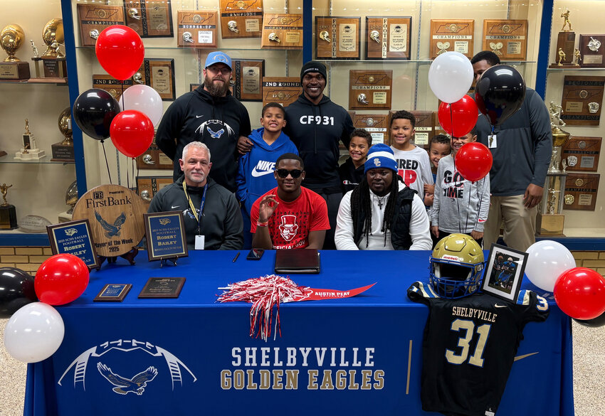Robert Bailey (center) officially signed with Austin Peay on Wednesday afternoon with Shelbyville Central Head Coach Jud Dryden (left) seated next to him.