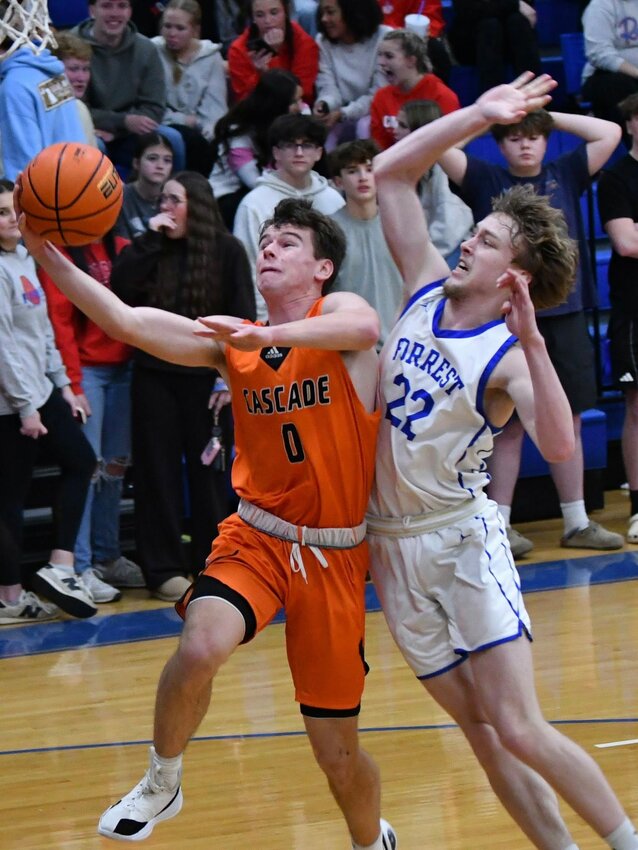 Cascade's Henry Stone (0) goes up strong against Chapel Hill's Elijah Leverette (22) in Friday's District 9-AA road win. Stone scored 11 points while pulling down seven rebounds.