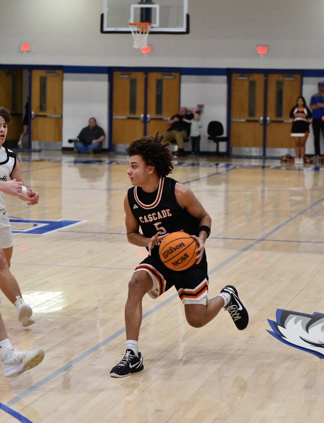 Cascade's Kaleb Kelso (5) looks to attack the defense in Tuesday's Region 5-AA semifinal against Loretto. In his final career game at Cascade, the senior guard finished with 10 points and three assists.