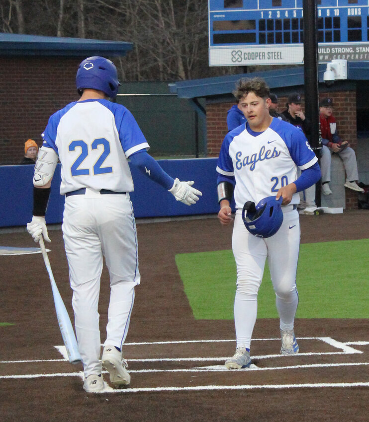 Case Davis (20) touches home plate in the Golden Eagles' big win over Warren County on Monday. Davis finished a perfect 4-for-4 at the plate with four RBIs and a double.