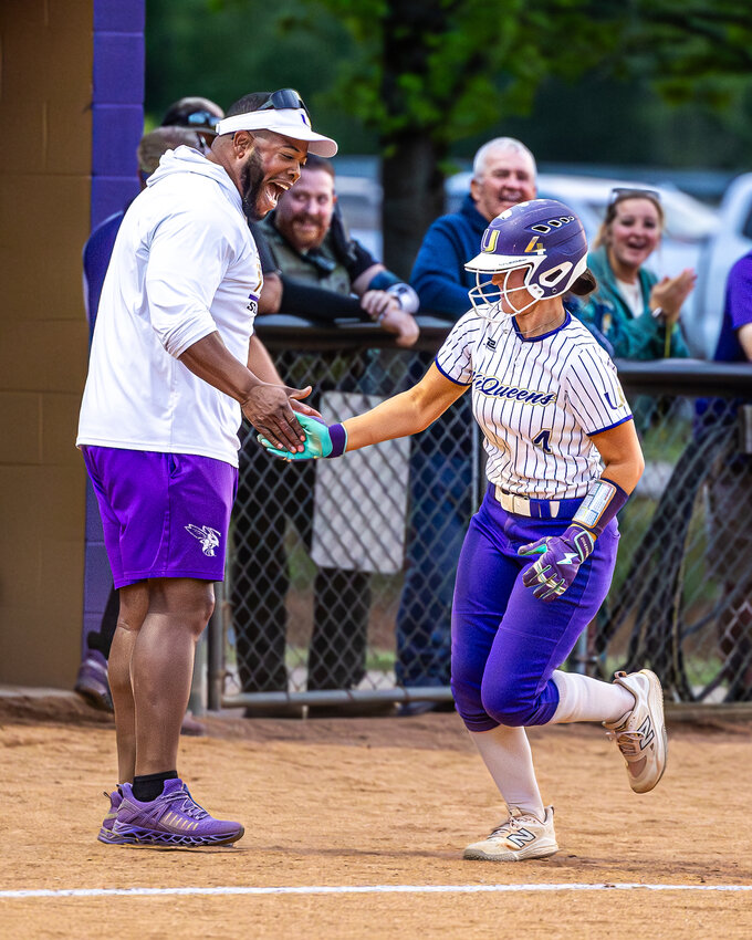 Community HC Cam Farrell (left) and Gracie Daniel (4) celebrate after Daniel's two-out go-ahead 3-run home run in the bottom of the 6th inning of Tuesday's win over Summertown.