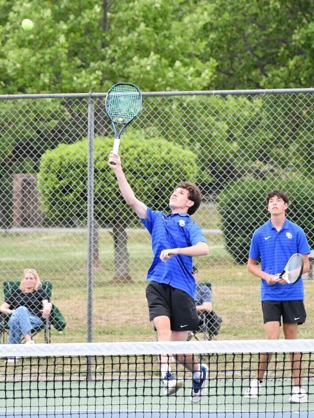 Shelbyville Central's Tanner Johnson (front) returns a Tullahoma shot while Carter Watson (back) looks on. The pairing won their doubles match, 8-4.