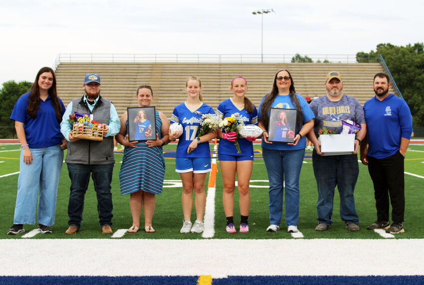 Shelbyville Central's Kena Dotson (17) and MG Marshall (16, right-center), were honored for Senior Night before Friday's contest against Boyd Christian.