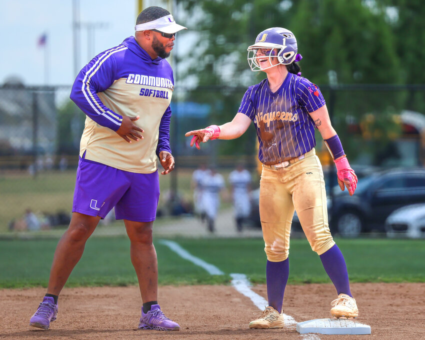 Community's Haylee Webb (1) with Head Coach Cam Farrell (left) after her RBI-triple in the top of the sixth inning of Tuesday's win over Kingston. Webb finished 2-for-3 with an additional double and three total RBIs.