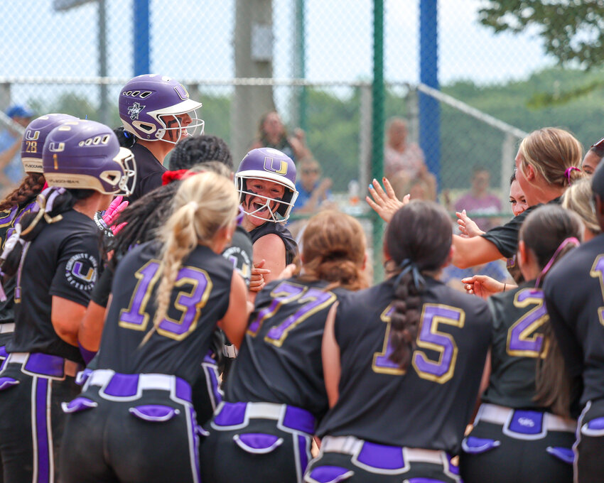 The Viqueens celebrate Gracie Daniel's (middle) fifth-inning home run on Wednesday morning.