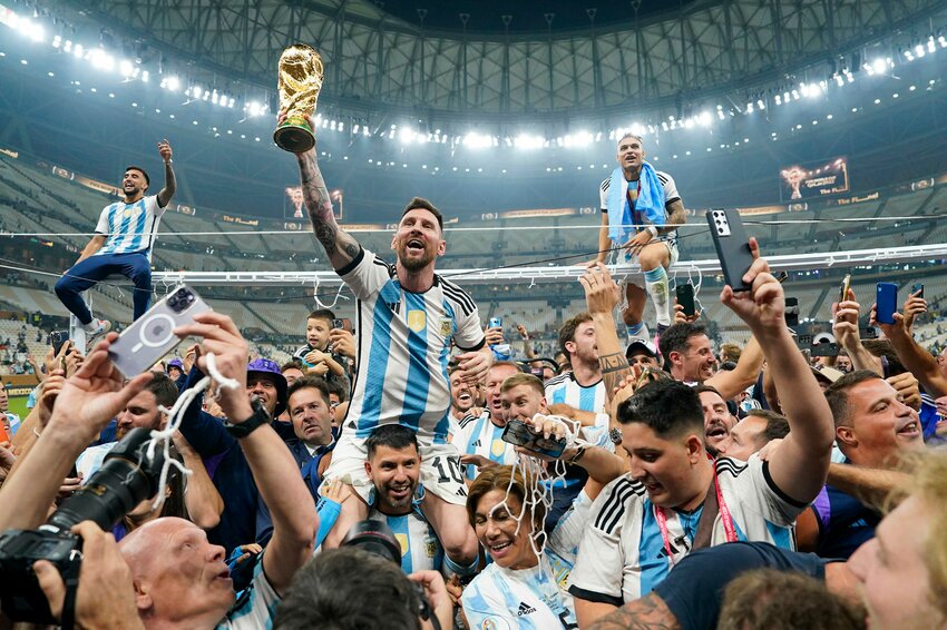 Lionel Messi (10, center) holds up the World Cup trophy after winning it for the first time in 2022. Argentina is looking to defend its title in the United States for the 2026 edition with the tournament kicking off on Thursday afternoon.