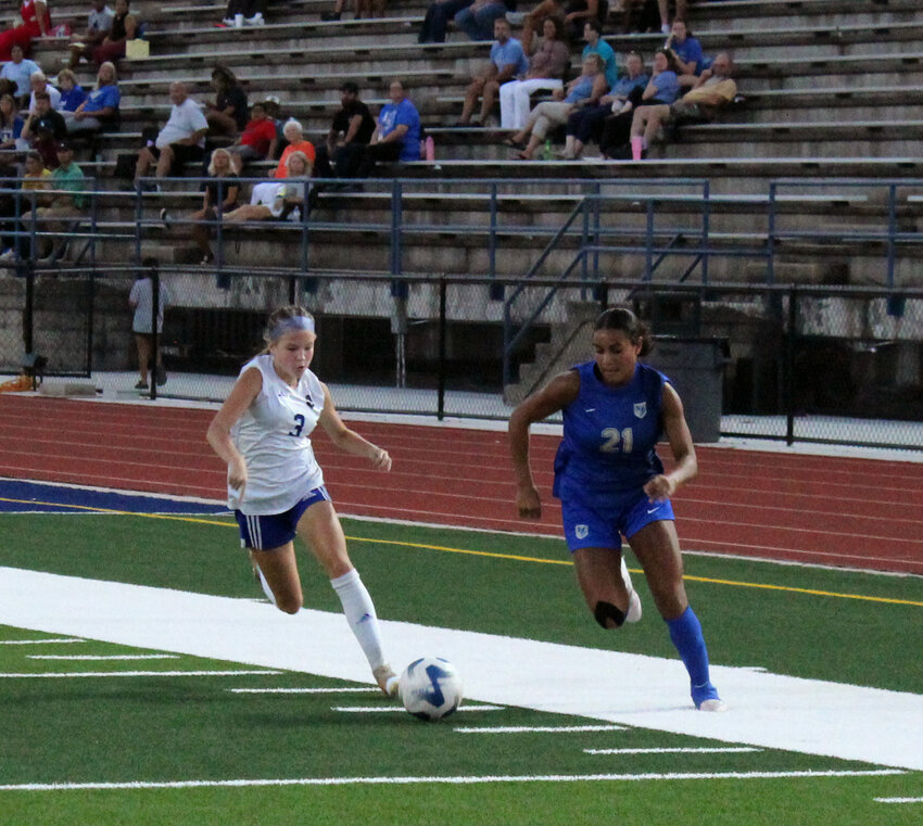 Shelbyville Central's Dara Frazier (21) beats Nolensville's Layla Shelton to the ball before drawing a foul. Frazier scored the last-minute equalizer on Tuesday for the Eaglettes.