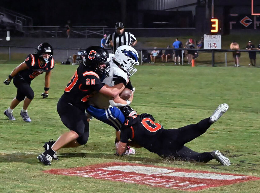 Cascade's Nate Zimmerman (20) and Braxtyn Burris (0) tackle the Summertown ballcarrier in Friday's loss to the Eagles. Zimmerman finished with 21 total tackles on defense while rushing for 75 yards and one touchdown on 14 attempts offensively. Burris made four receptions for 51 yards and one touchdown as well as pulling down an interception.