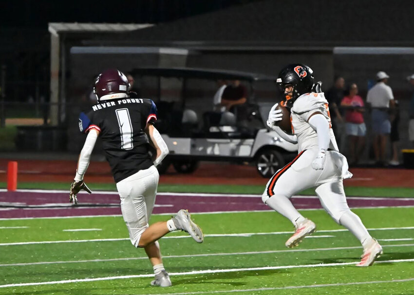 Cascade's Isaac Rimes (54) heads for the end zone on a first quarter scoop-n-score in Friday's win at Eagleville.