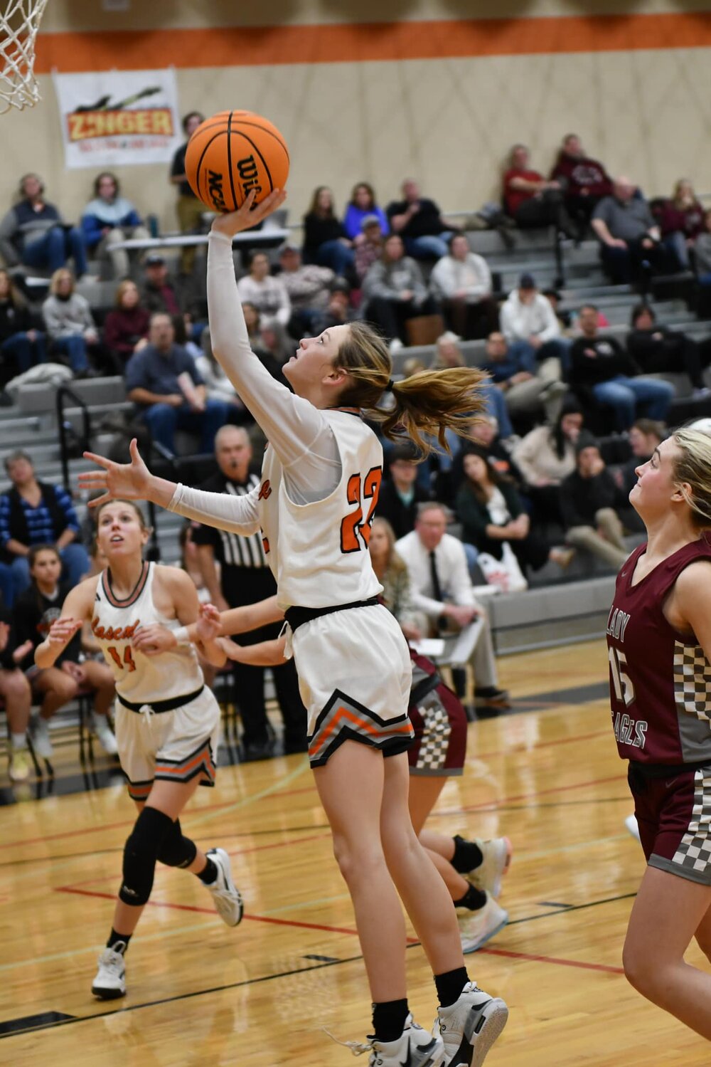 Cascade's Kaegan Young (22) puts up a left-handed layup for two of her team-high 18 points.